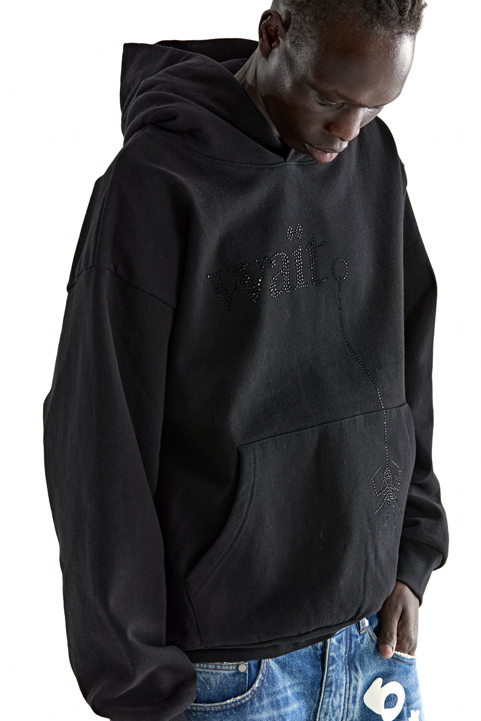 Black 13oz cotton fleece hoodie with rhinestone "Wait" detail, kangaroo pocket, and rib knit trim.