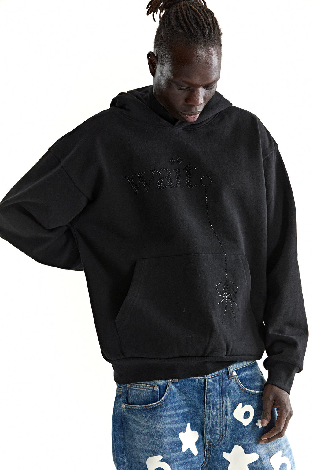 Black cotton fleece hoodie with rhinestone "Wait" detail, kangaroo pocket, and rib knit trim.
