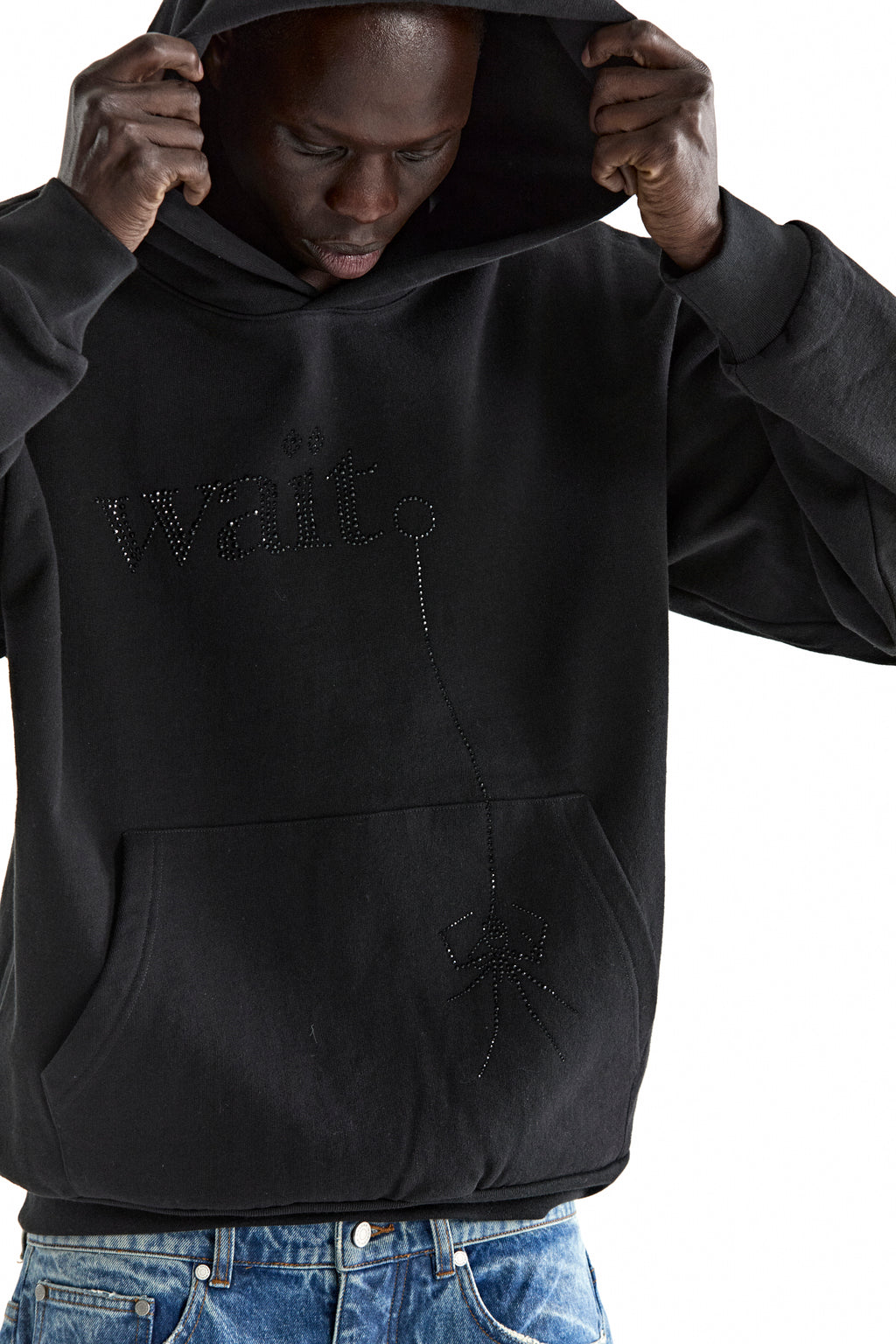 Black 13oz cotton fleece WAIT STONE HOODIE with rhinestone "Wait" and spider graphic, kangaroo pocket.