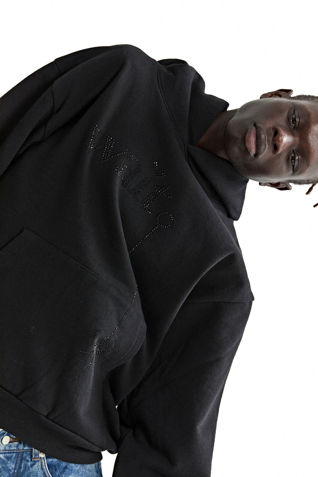 Black 13oz cotton fleece hoodie with rhinestone "Wait" detail and kangaroo pocket, worn by a model.