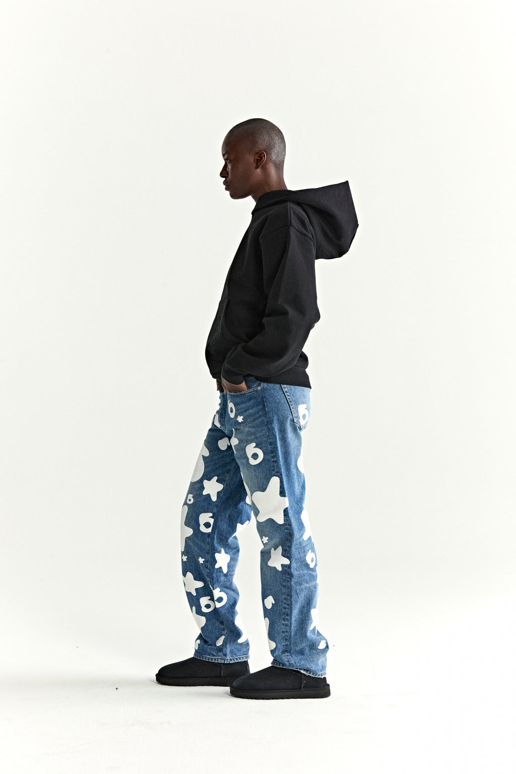 Black cotton fleece hoodie with rhinestone "Wait" detail on front, worn by a model in profile.