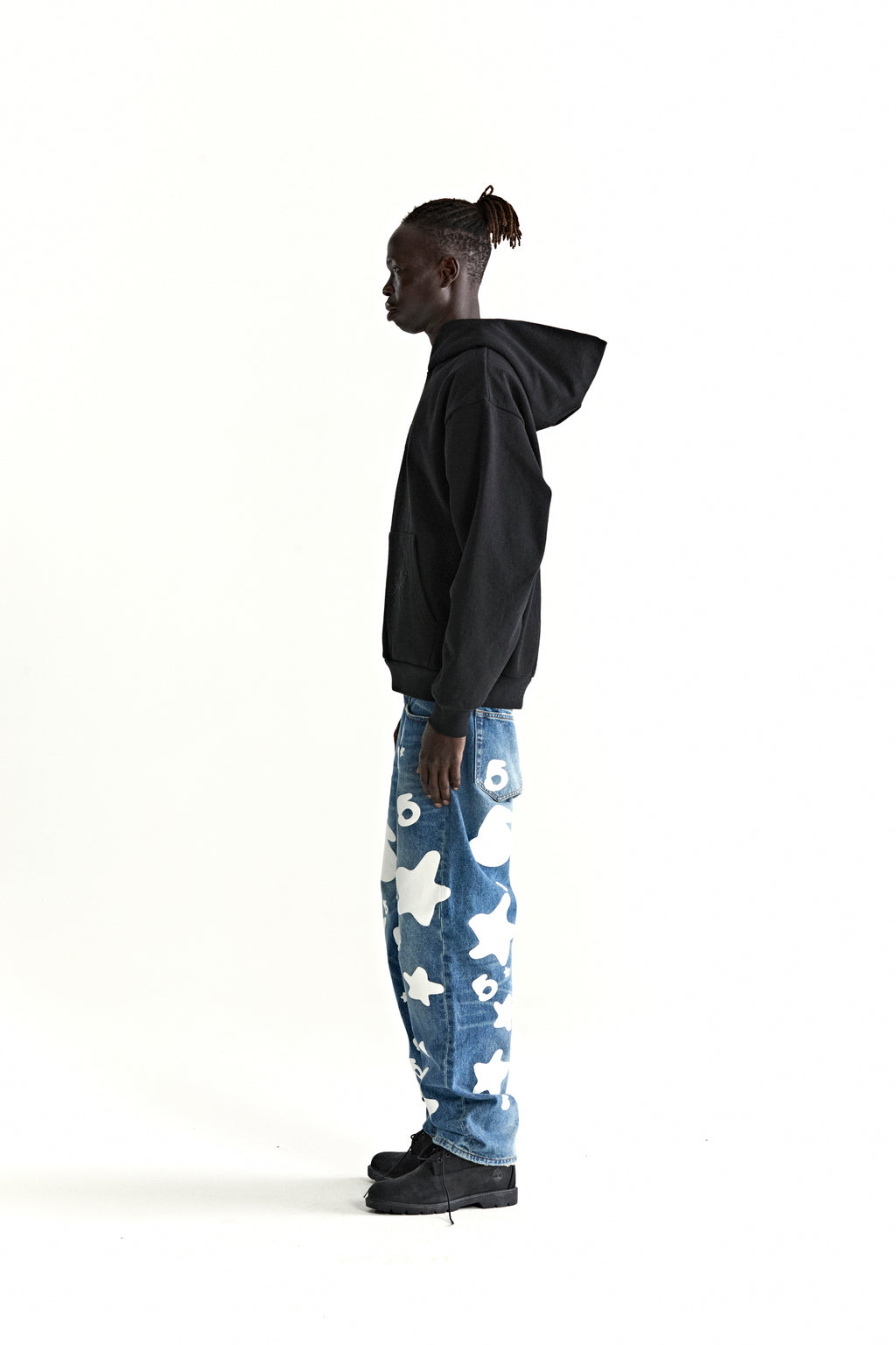 Model wearing a black WAIT STONE HOODIE with rhinestone detail, kangaroo pocket, and rib knit trim.