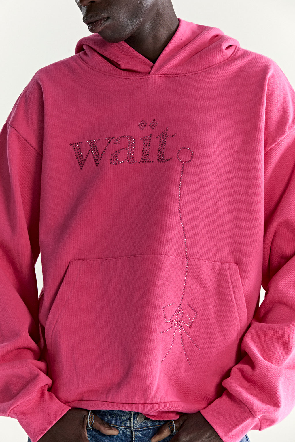 Pink cotton fleece hoodie with rhinestone "Wait" graphic and fishing line design.