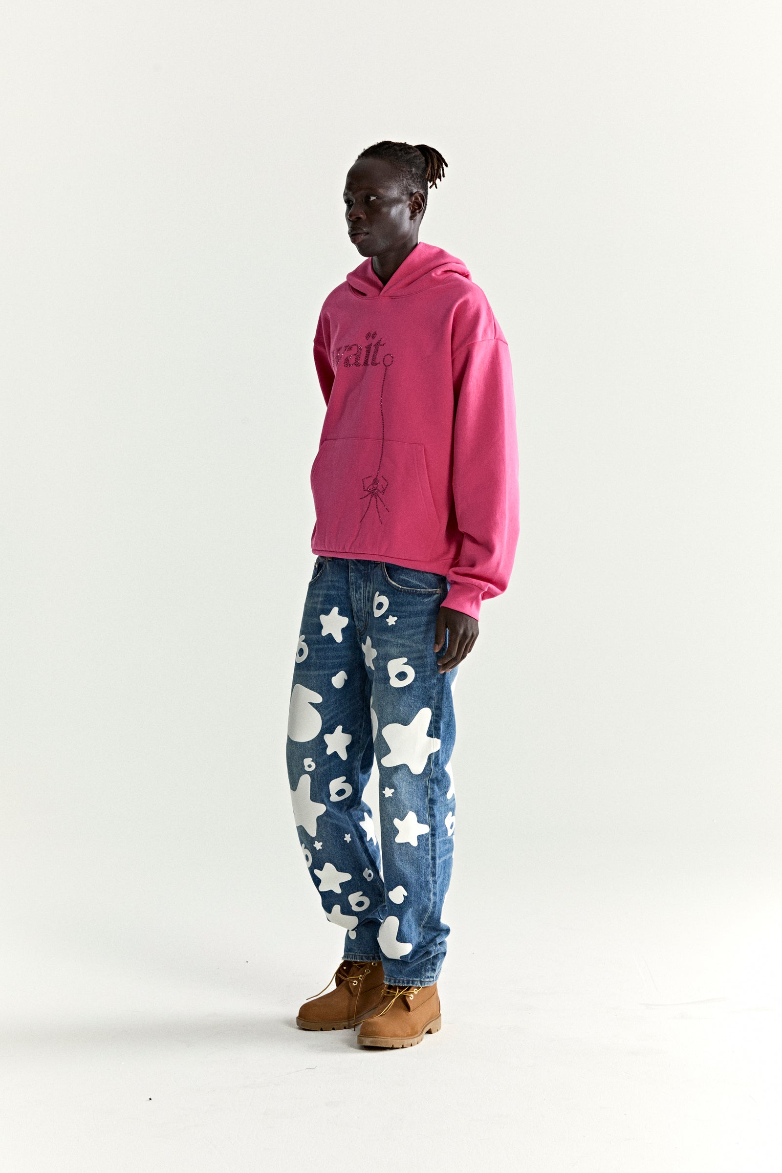 Pink WAIT STONE HOODIE with rhinestone 'Wait' detail, kangaroo pocket, and rib knit trim.