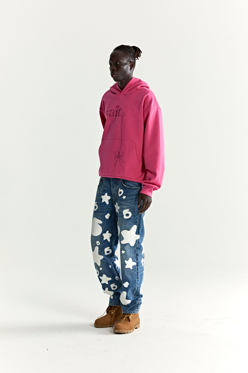 Pink WAIT STONE HOODIE with rhinestone 'Wait' detail, kangaroo pocket, and rib knit trim.