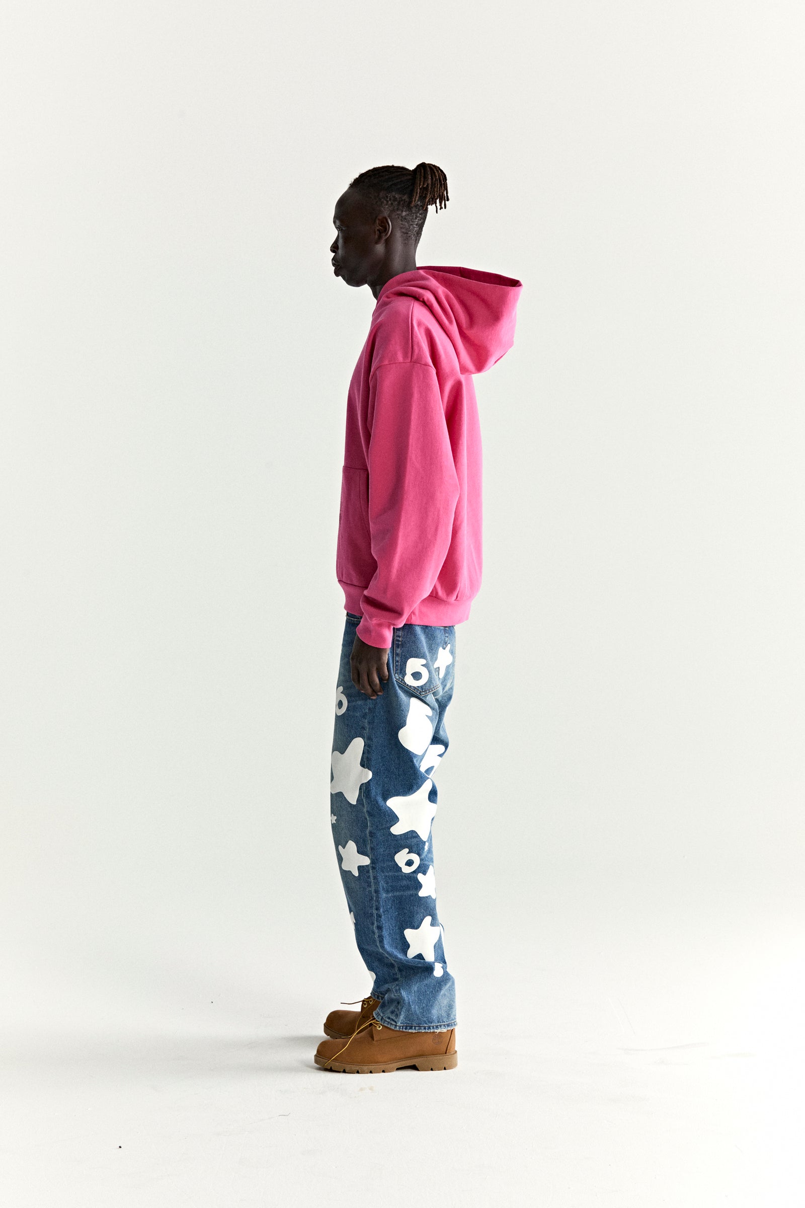 Man in a pink WAIT STONE HOODIE with rhinestone detail, kangaroo pocket, and rib knit hem/cuffs.