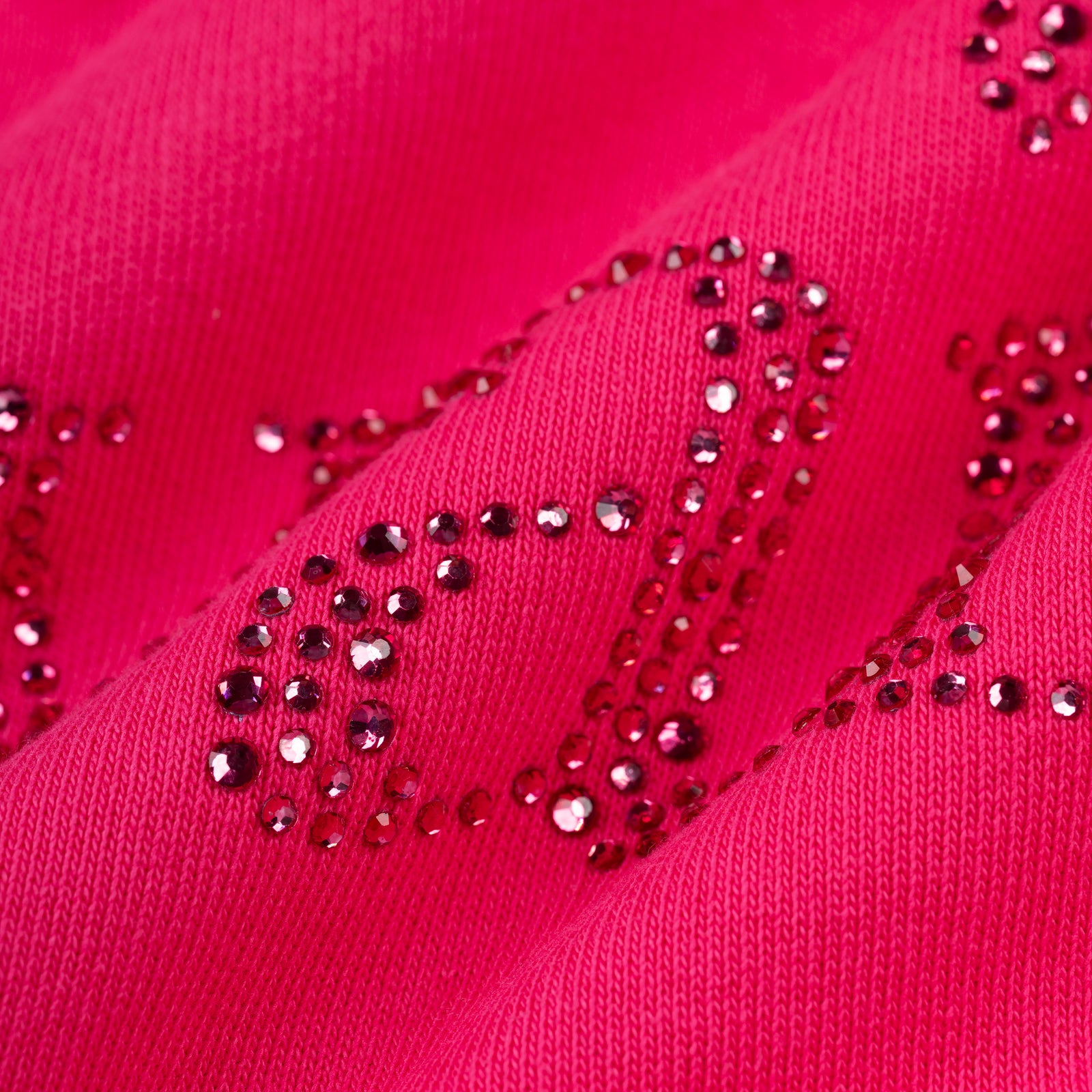 Close-up of a vibrant pink cotton fleece hoodie with "Wait" spelled out in sparkling pink rhinestones.