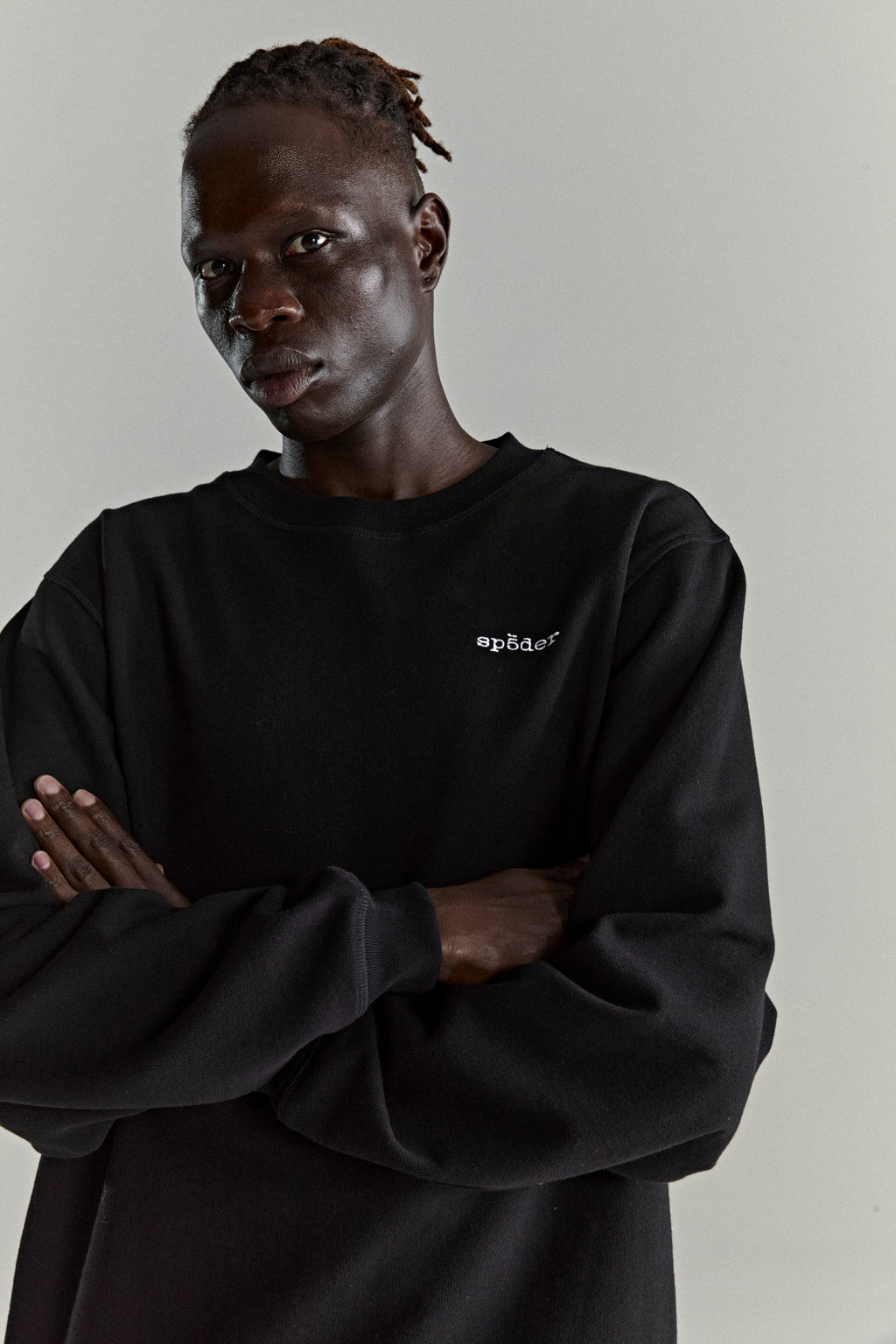 Black CORE CREWNECK, 13oz brushed fleece, with embroidered 'SP5DER' logo on chest.