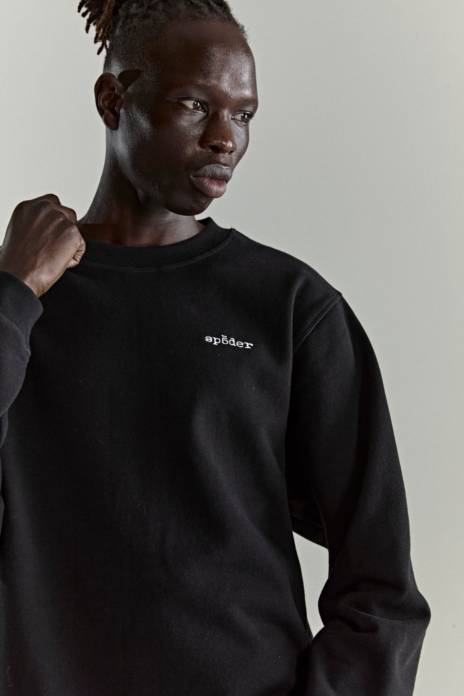 Black CORE CREWNECK sweatshirt with embroidered 'SP5DER' logo, ribbed collar, hem, and cuffs.