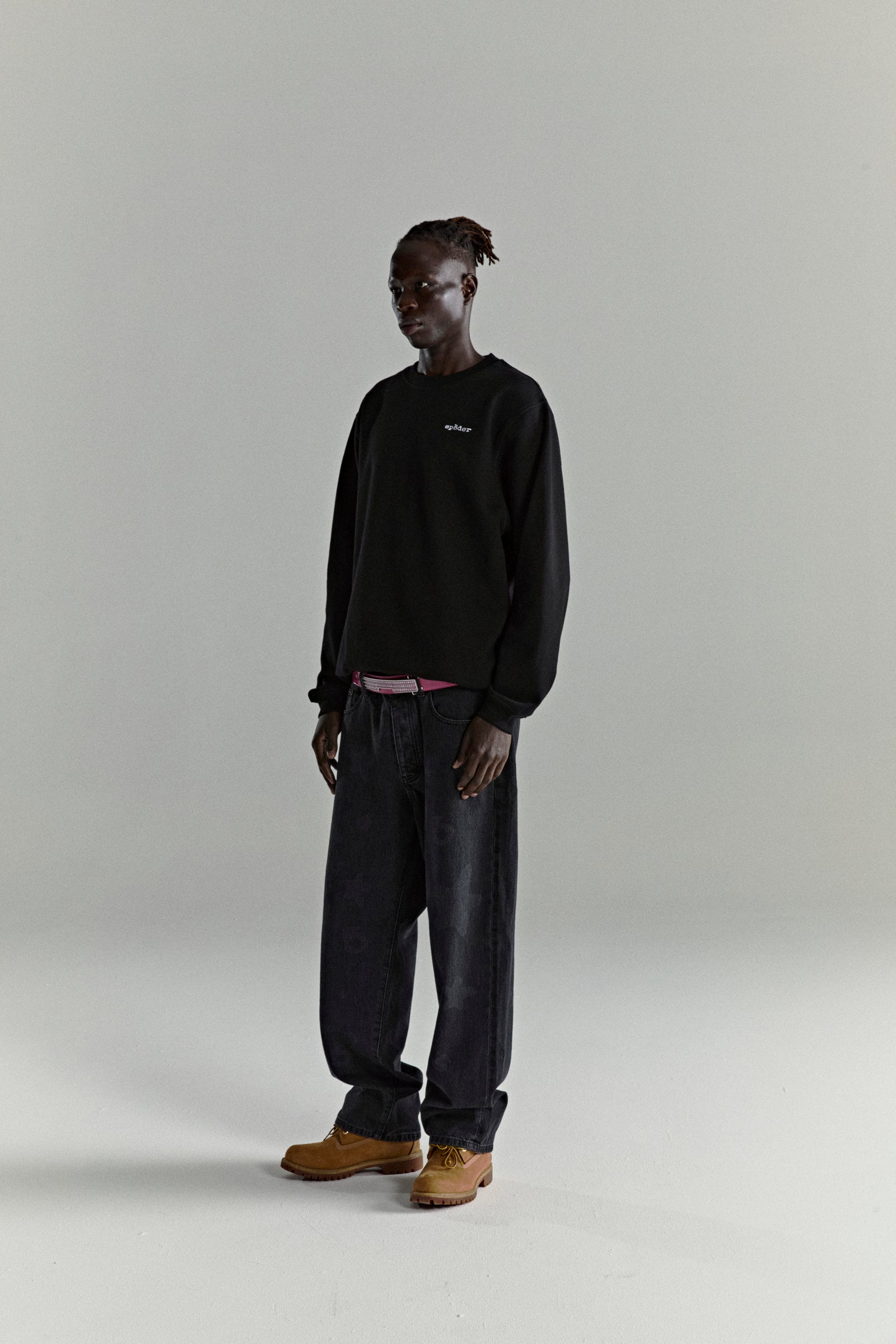 Black CORE CREWNECK, 13oz cotton brushed fleece with embroidered 'SP5DER' logo, worn by a model.