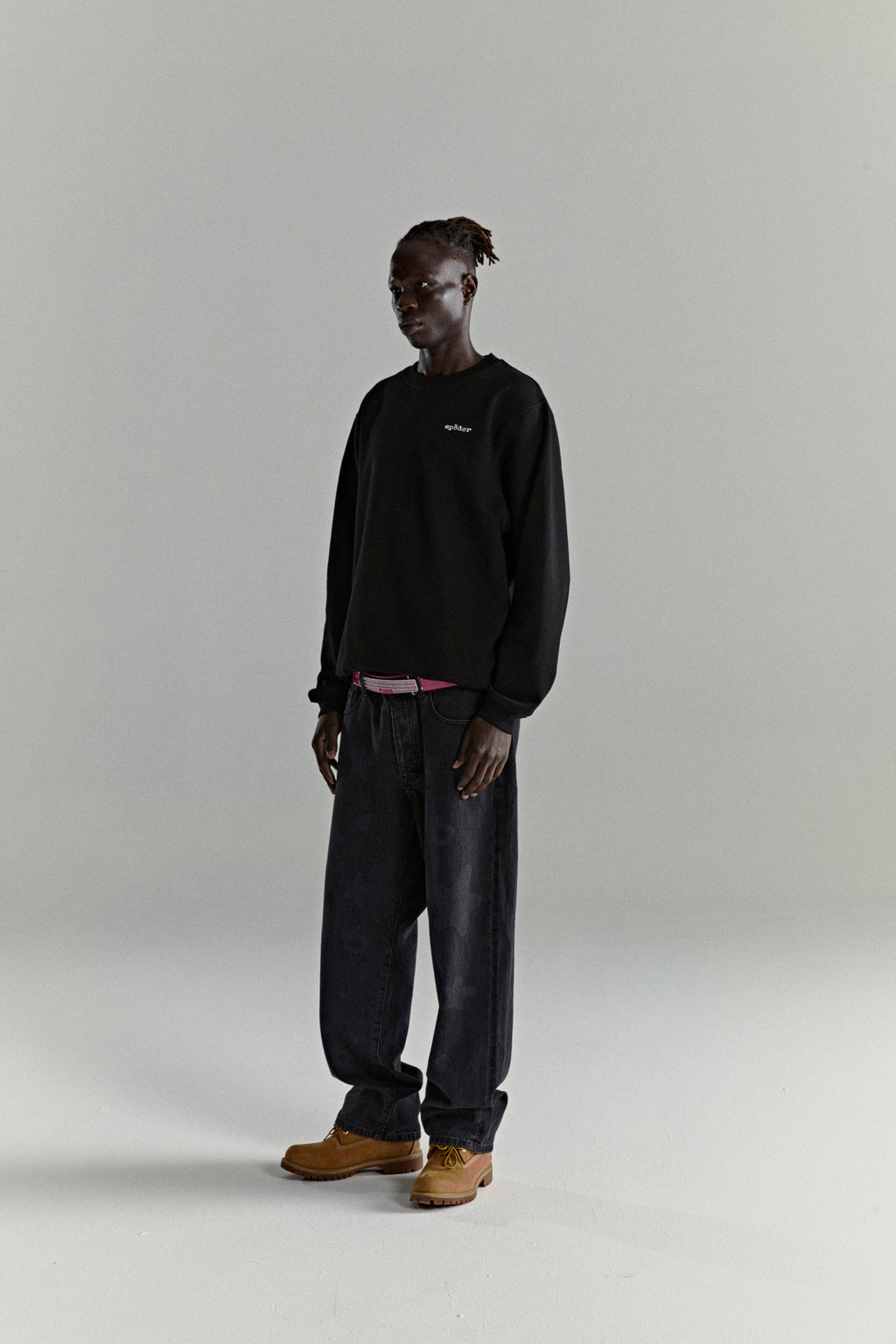 Black CORE CREWNECK, 13oz cotton brushed fleece with embroidered 'SP5DER' logo, worn by a model.