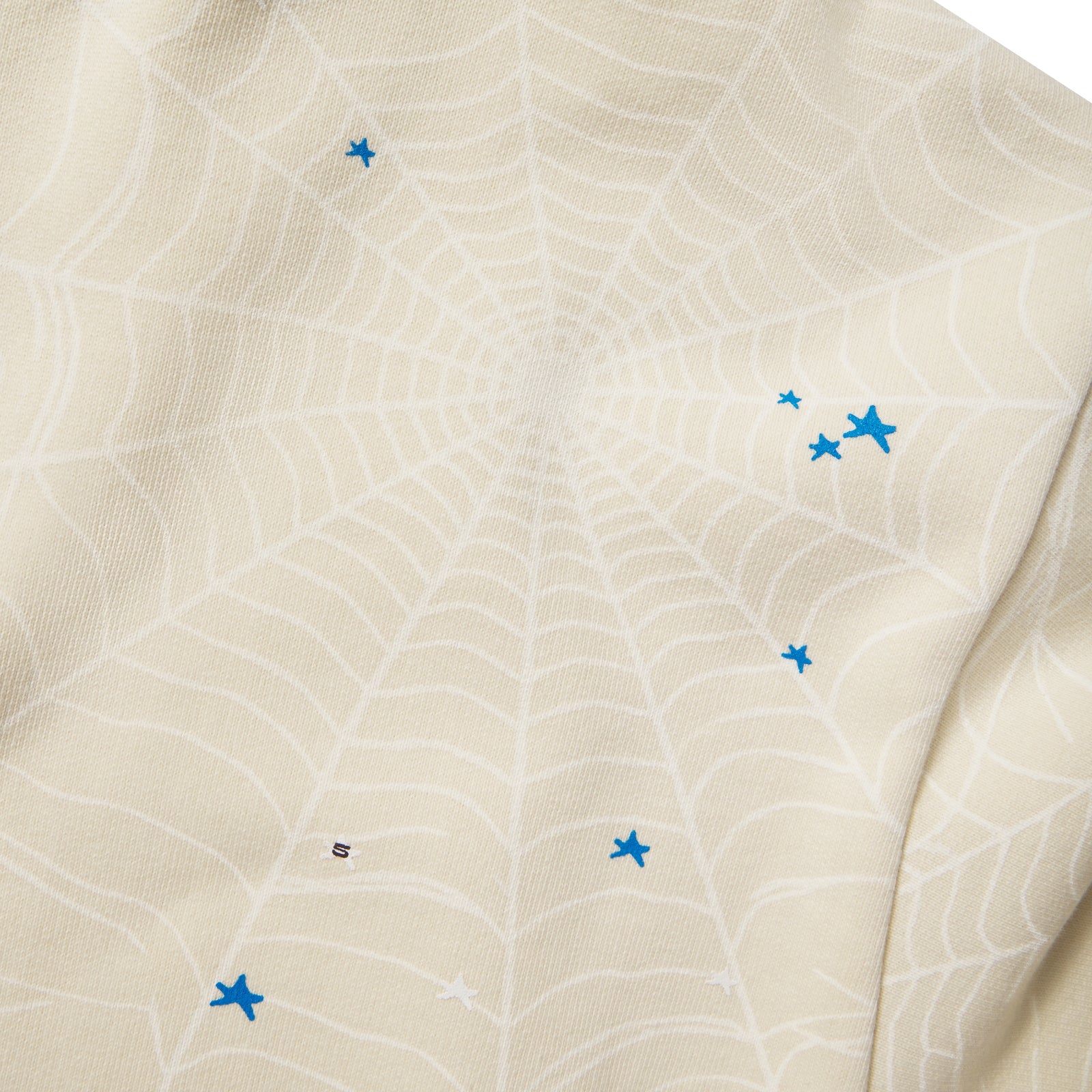 Cream 13oz cotton fleece hoodie featuring a subtle web graphic print and scattered blue star puff print details.