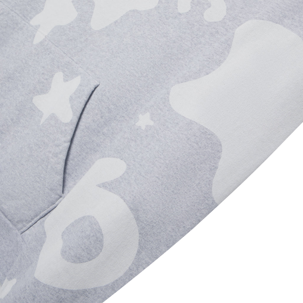 Close-up of a light grey Beluga V2 Hoodie, showing white puff print design, kangaroo pocket, and soft fleece texture.
