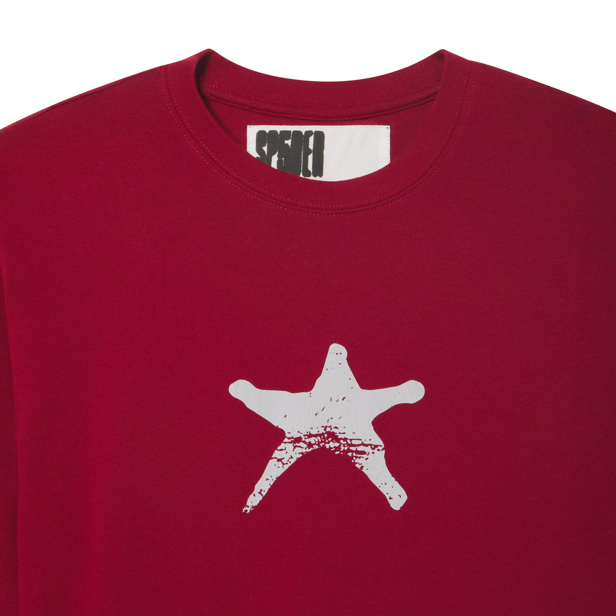 Deep red 100% cotton long sleeve tee featuring a white distressed star graphic print on the front and a branded neck label.