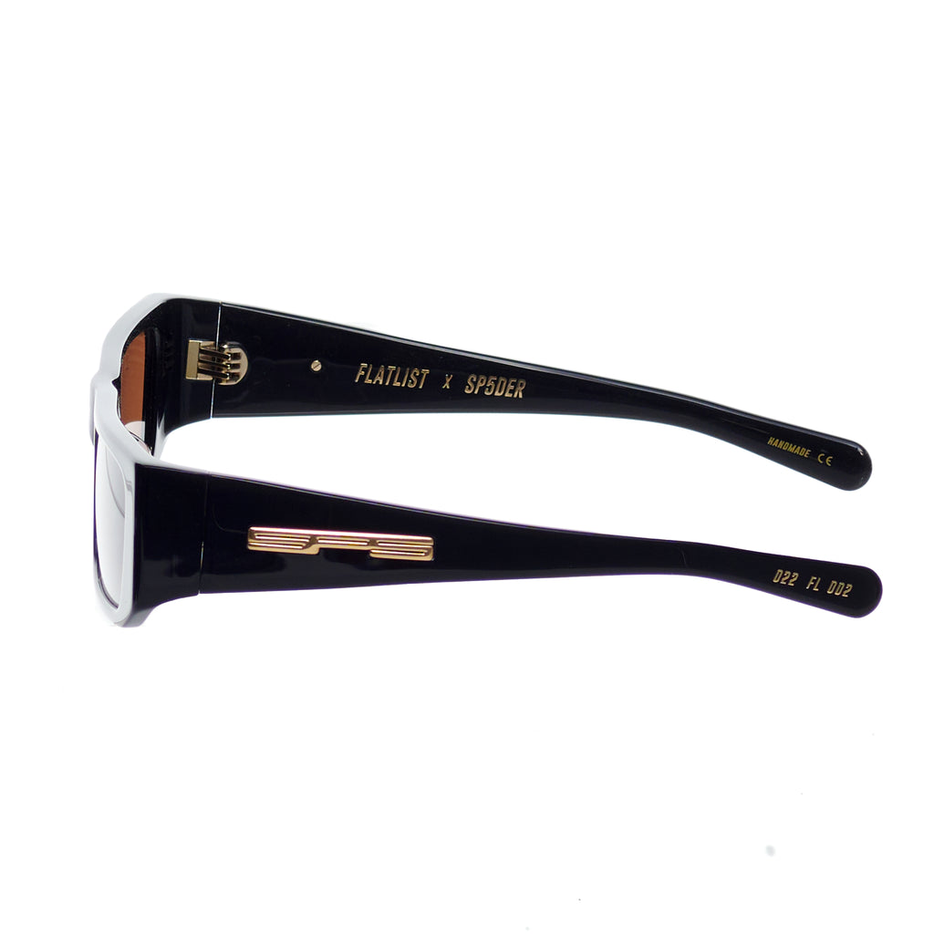 SP5 x FLATLIST 'SLUG' sunglasses: black Mazzucchelli acetate frame, brown lenses, gold branding.