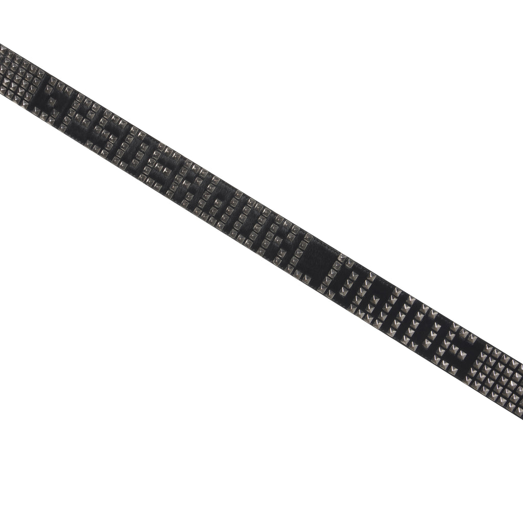 Black pony hair belt featuring silver-tone pyramid studs and studded logo lettering on a diagonal strap.