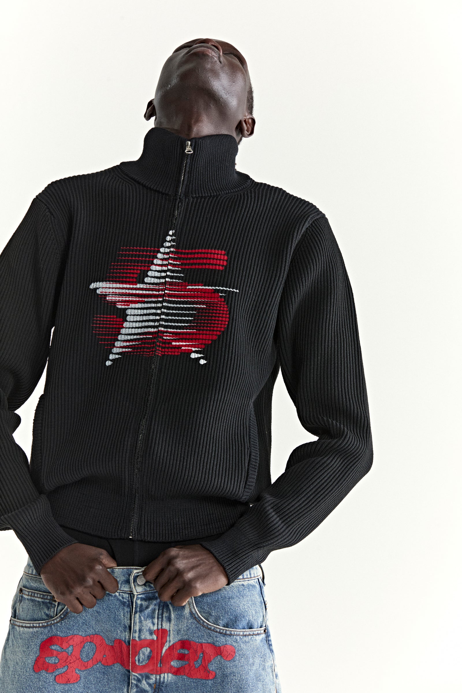 Black ribbed wool/cotton zip sweater with stand collar and red/white graphic chest print.
