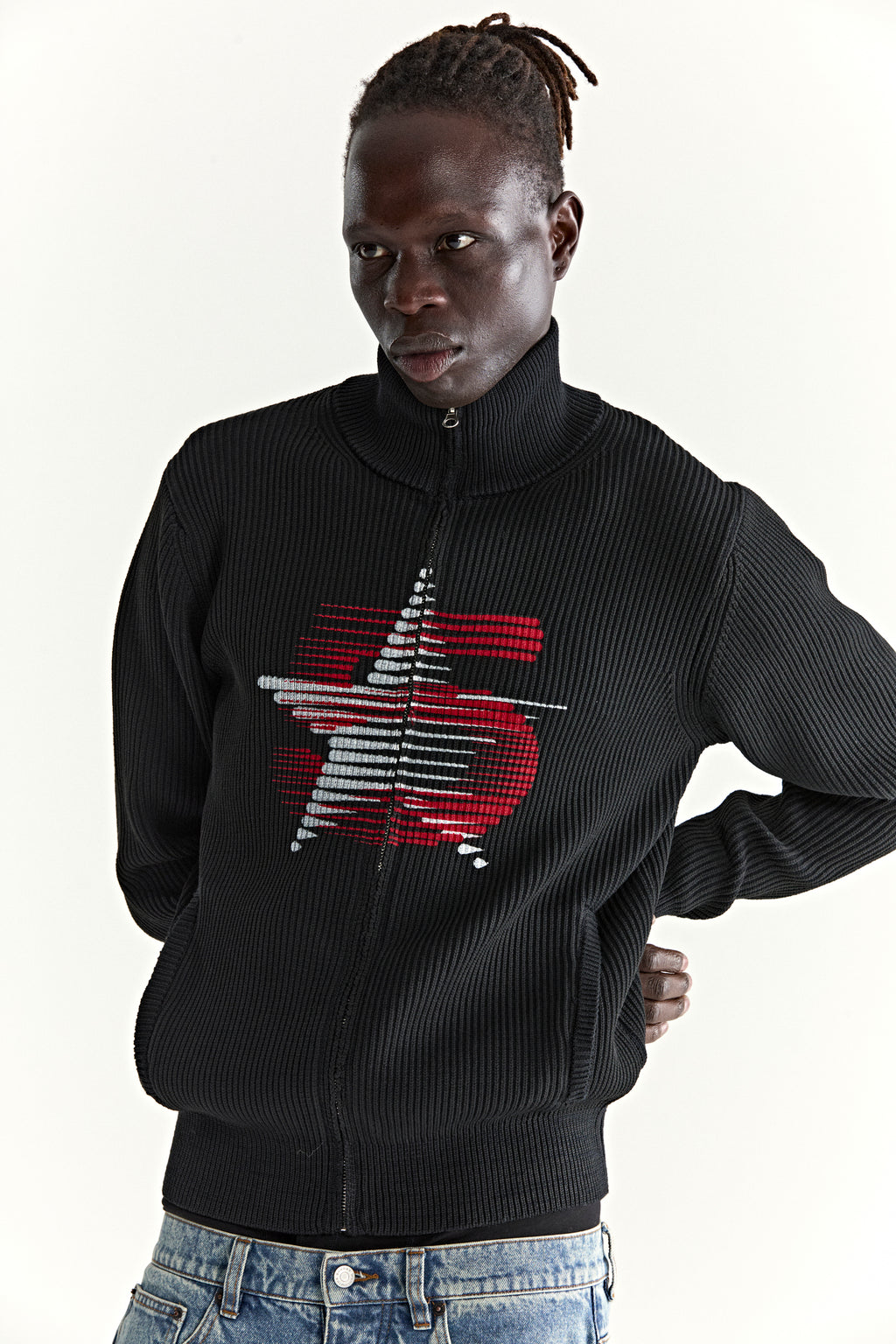 Black rib-knit wool/cotton blend zip sweater with stand collar and red graphic at chest.