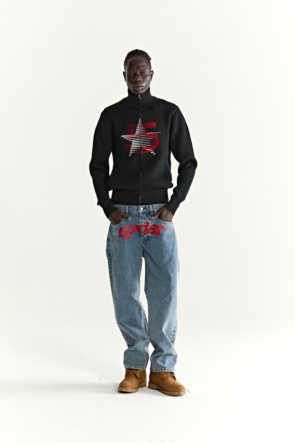 Black ribbed wool/cotton zip sweater with a red and white 5-star graphic, worn by a model.