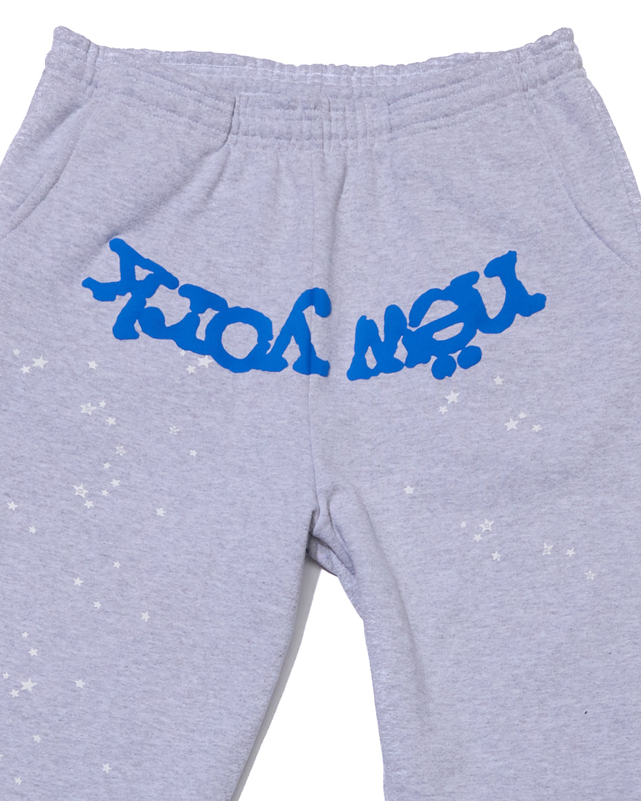 Light grey cotton fleece sweatpants with blue "NEW YORK" puff print and scattered white stars.
