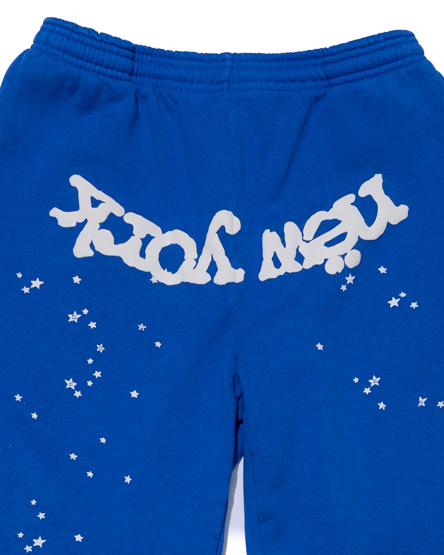 Blue cotton fleece sweatpants with white "NEW YORK" puff print and scattered stars.
