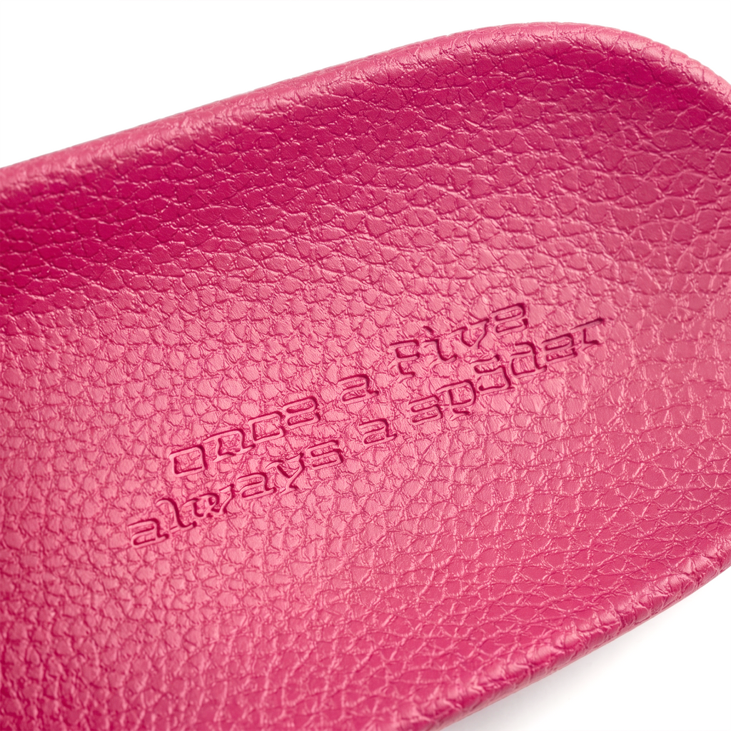 Diablo Pink Slide 001, close-up of textured pink rubber footbed with embossed "Once A Five Always A Spider" graphic print.