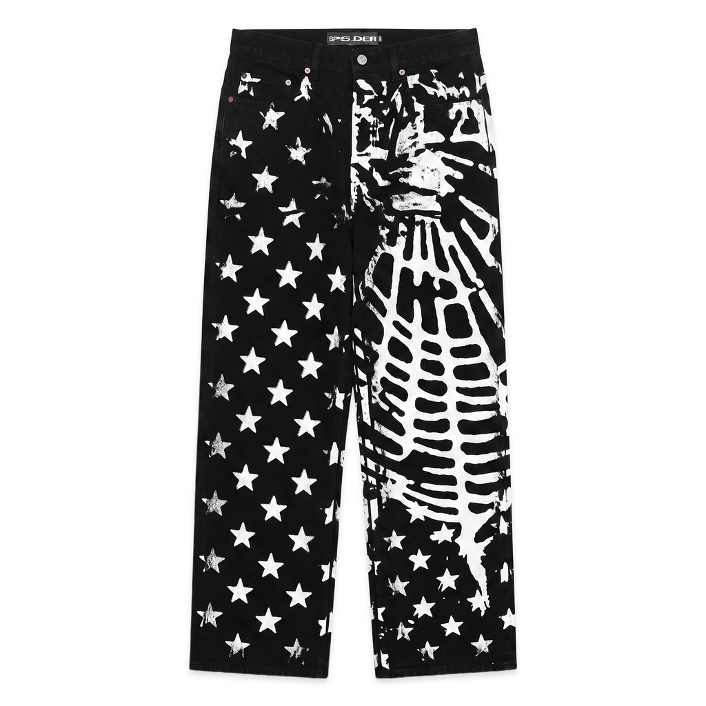 Black denim pants with white stars and web graphic print, five-pocket styling.