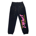 Black OG P*NK sweatpants with pink puff print text, yellow, blue, and pink star graphics.