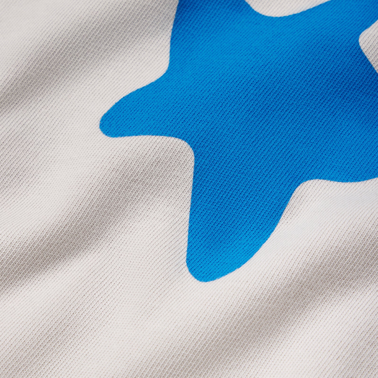 White 100% cotton tee featuring a bright blue plastisol graphic print of a beluga whale design.