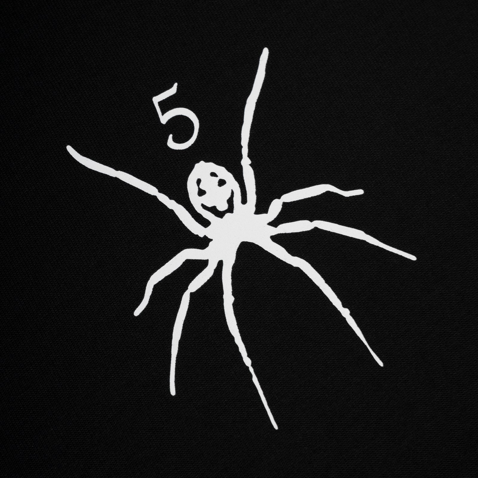 Black cotton TM Tee with white graphic print of a spider and the number 5.