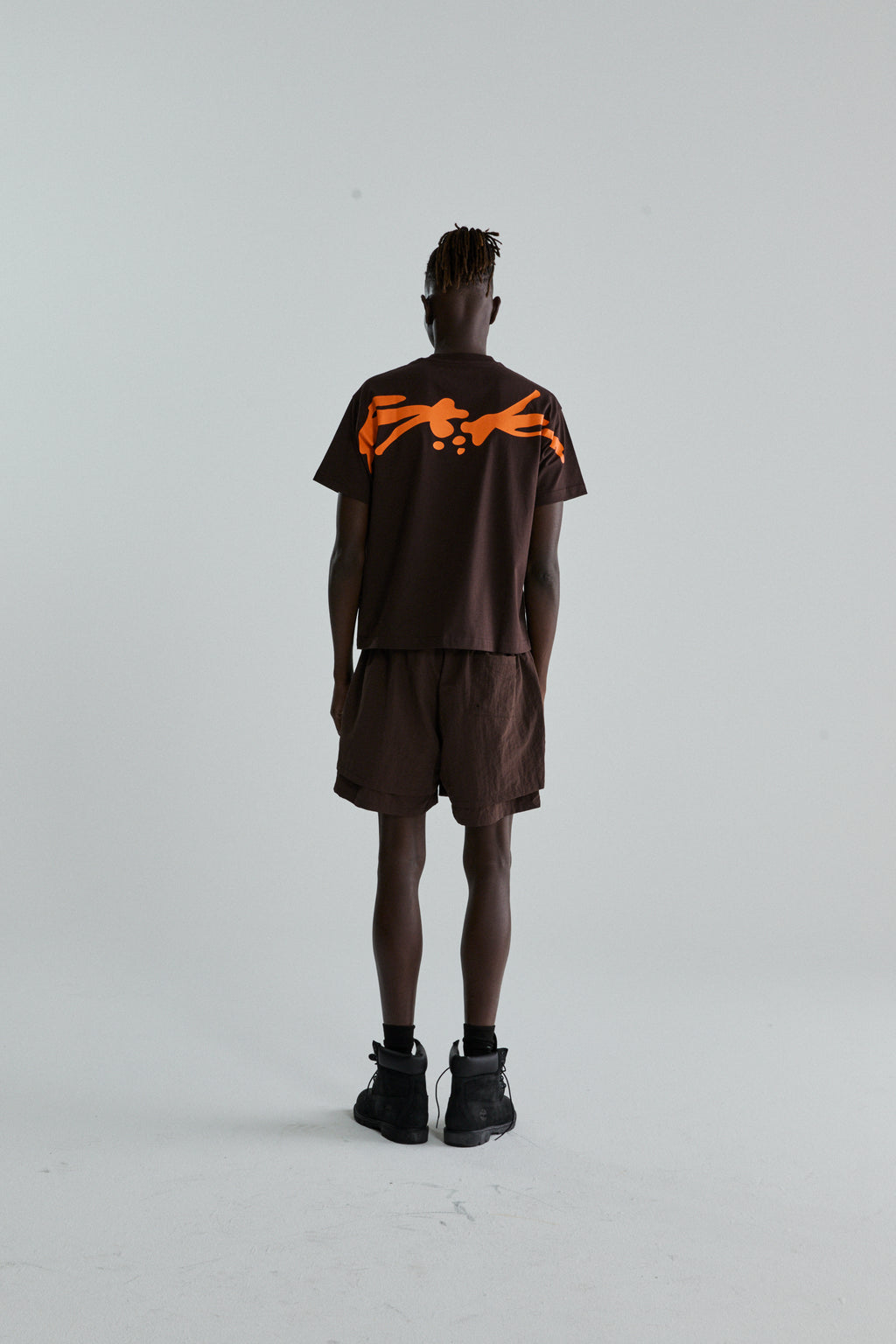 BROWN TM TEE ON MODEL