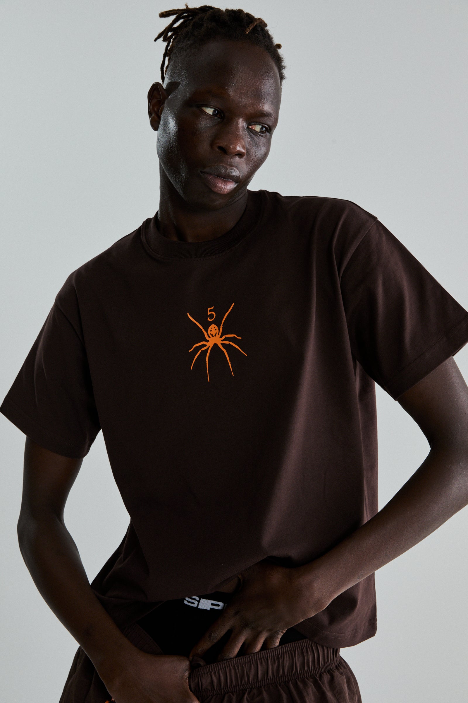 BROWN TM TEE ON MODEL