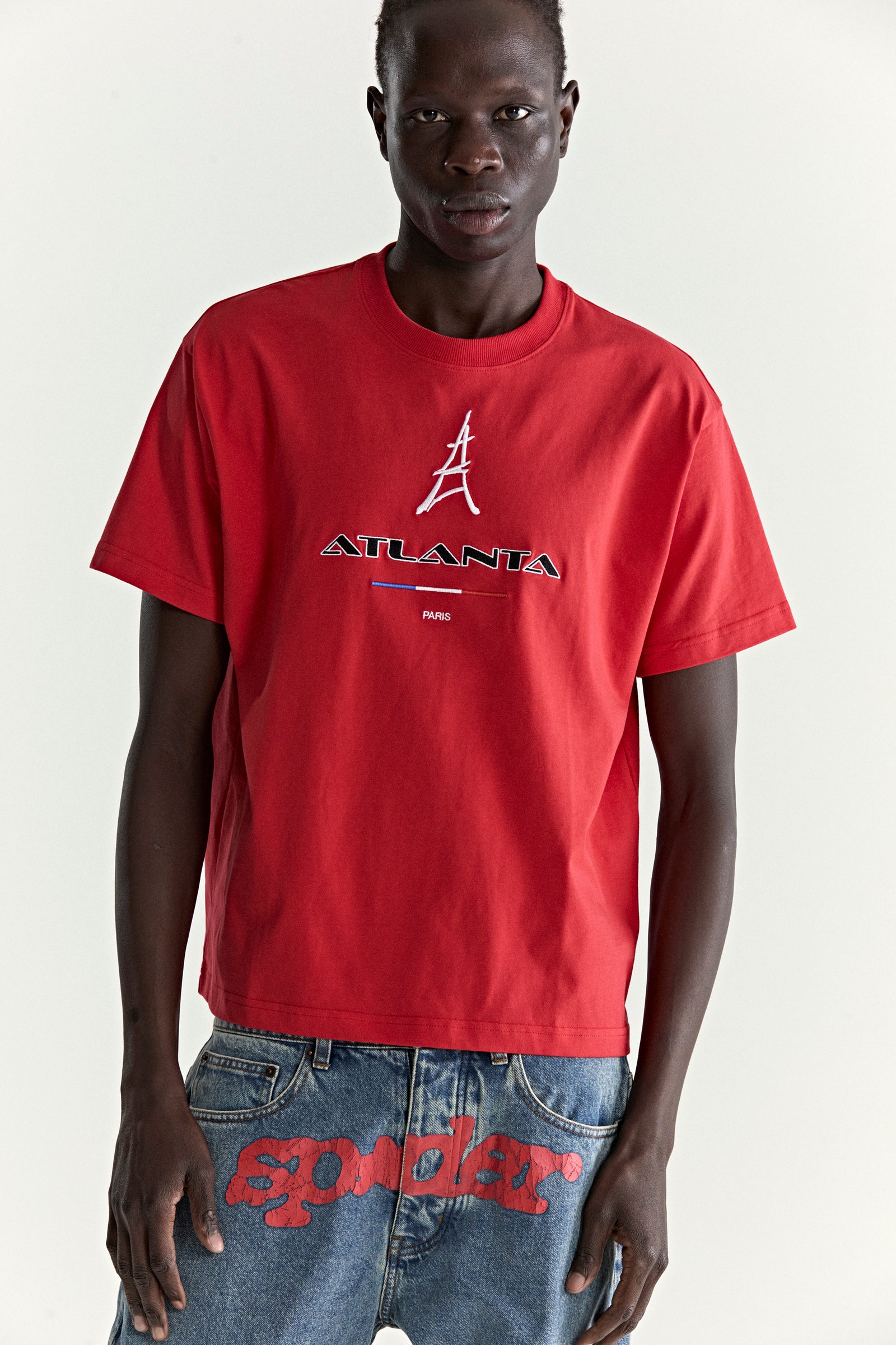 Red cotton tee with embroidered Atlanta Paris Eiffel Tower graphic.