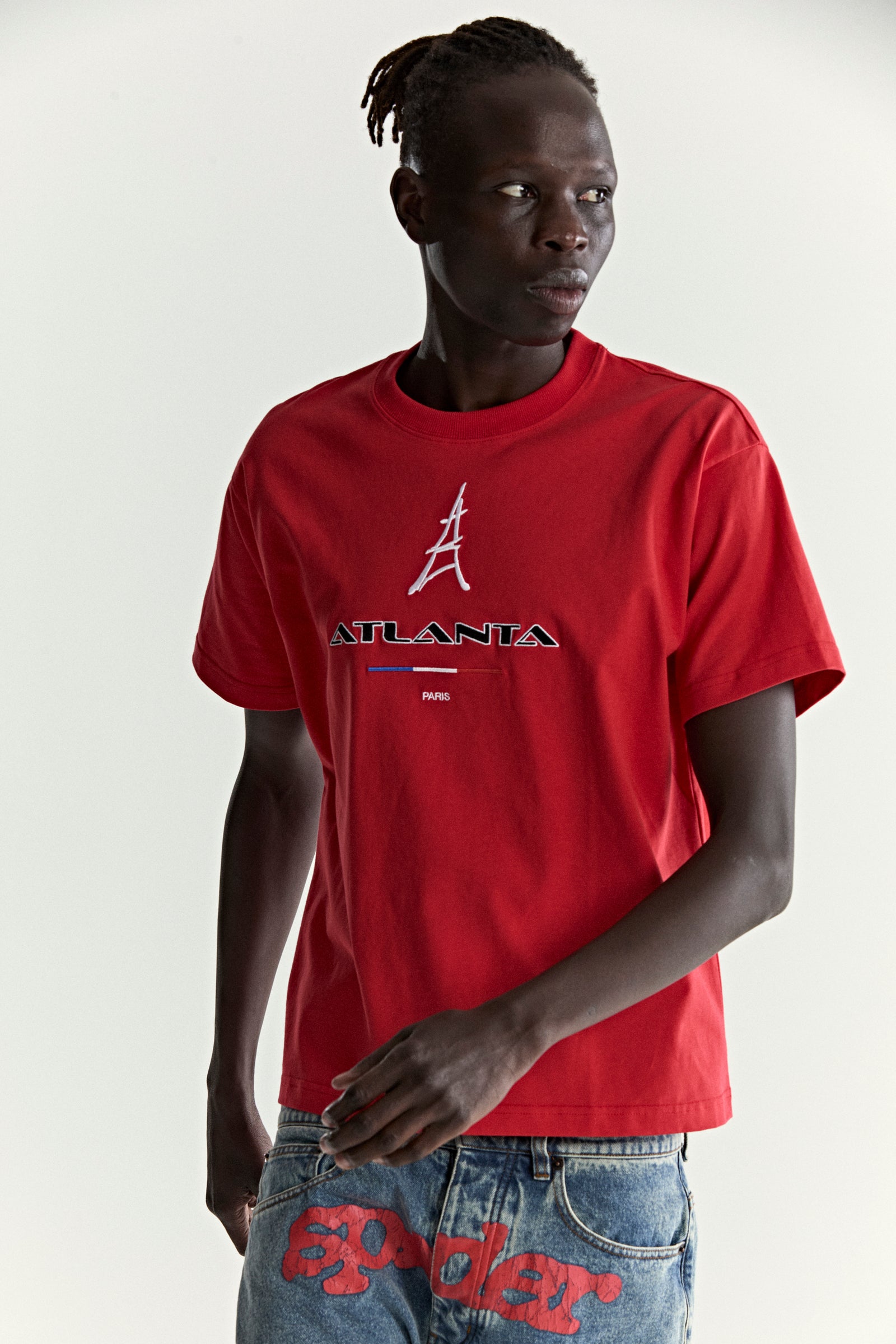 Red cotton tee with embroidered "ATLANTA PARIS" graphic and Eiffel Tower design.