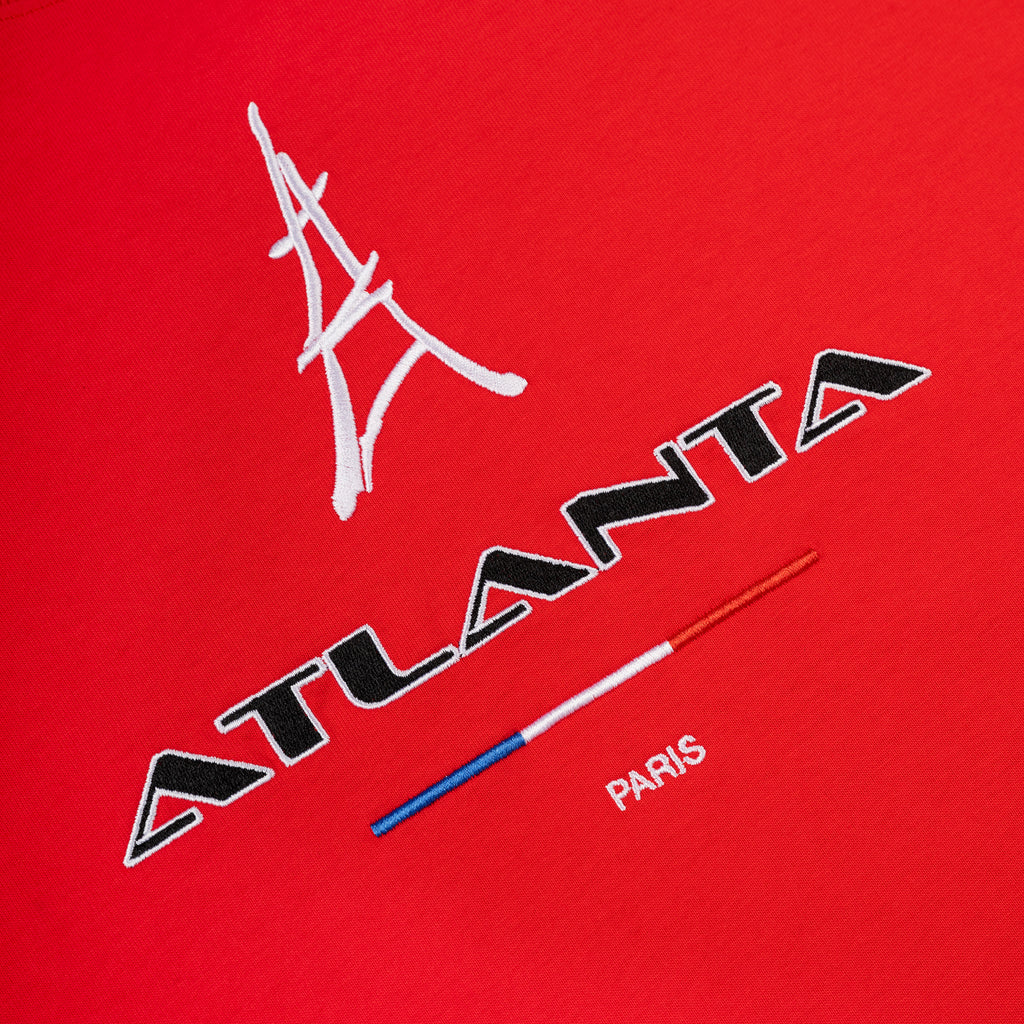 Red cotton tee with embroidered white Eiffel Tower, black "ATLANTA", and red, white, blue "PARIS" graphic.