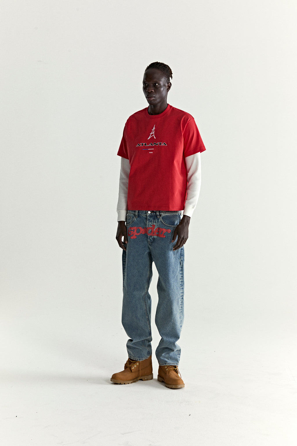 Red cotton ARAIGNÉE TEE with embroidered Eiffel Tower graphic, layered over a white long-sleeve shirt.