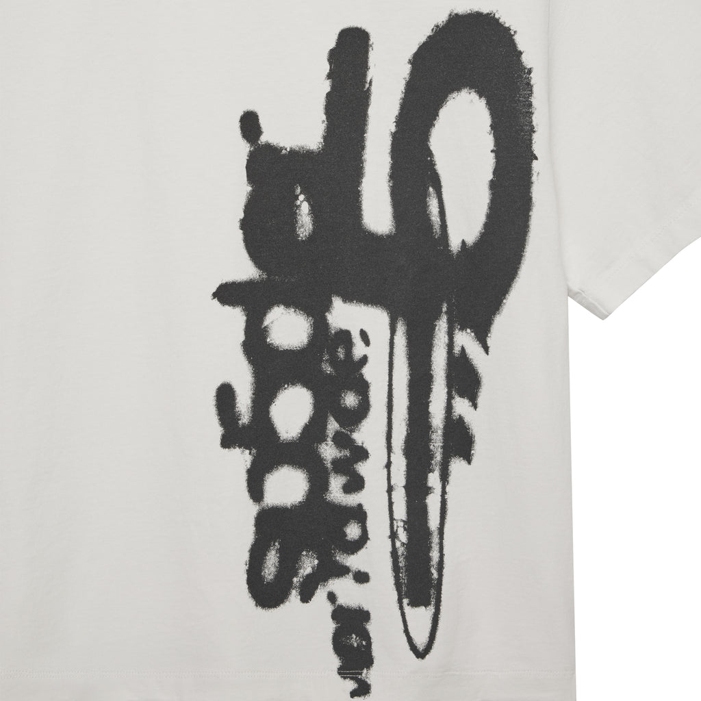 White 100% cotton SP5 5LUMINUM TEE with a bold black graphic print on the front.
