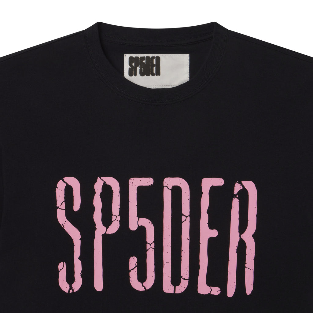 Black 100% cotton standard fit tee featuring a pink cracked graphic print logo on the chest and interior neck label.