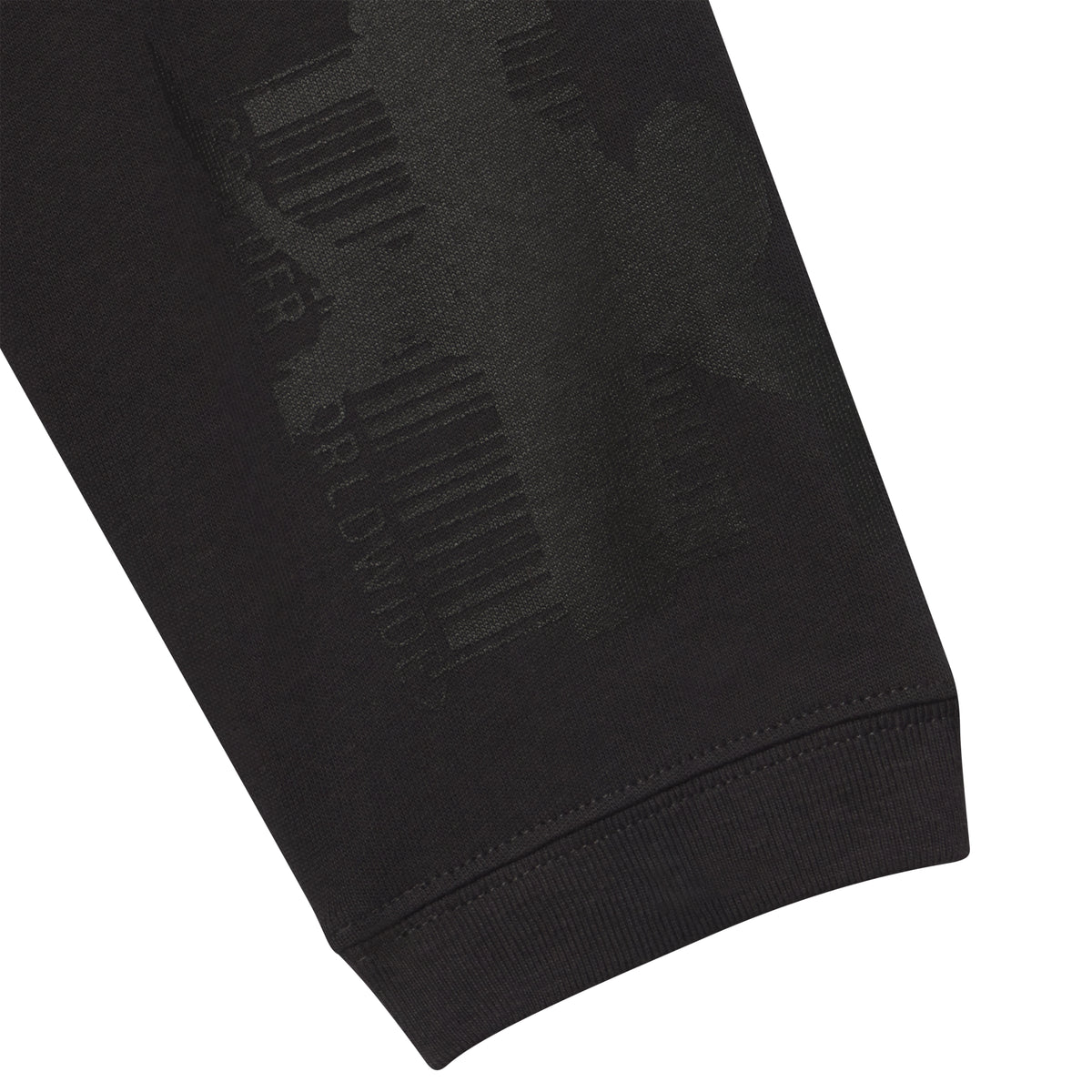 Black 100% cotton long sleeve tee featuring a tonal graphic print of barcodes and text on the sleeve.