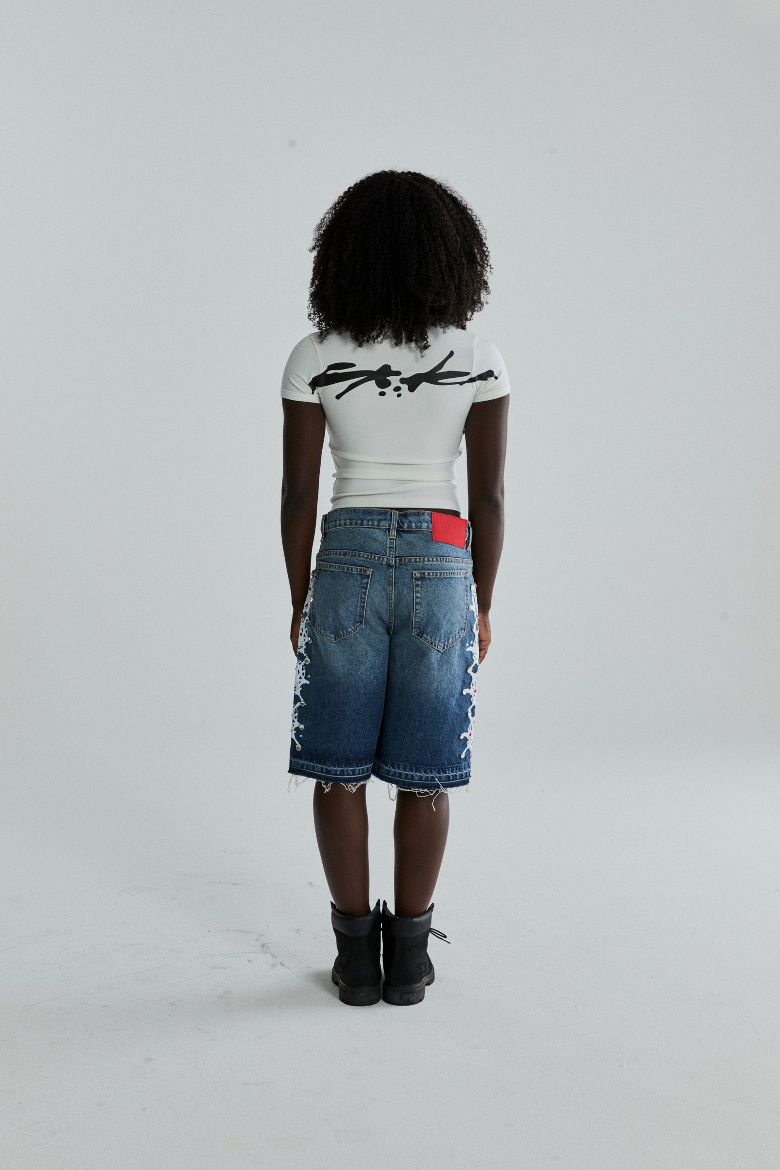 WHITE TM BABY TEE ON MODEL