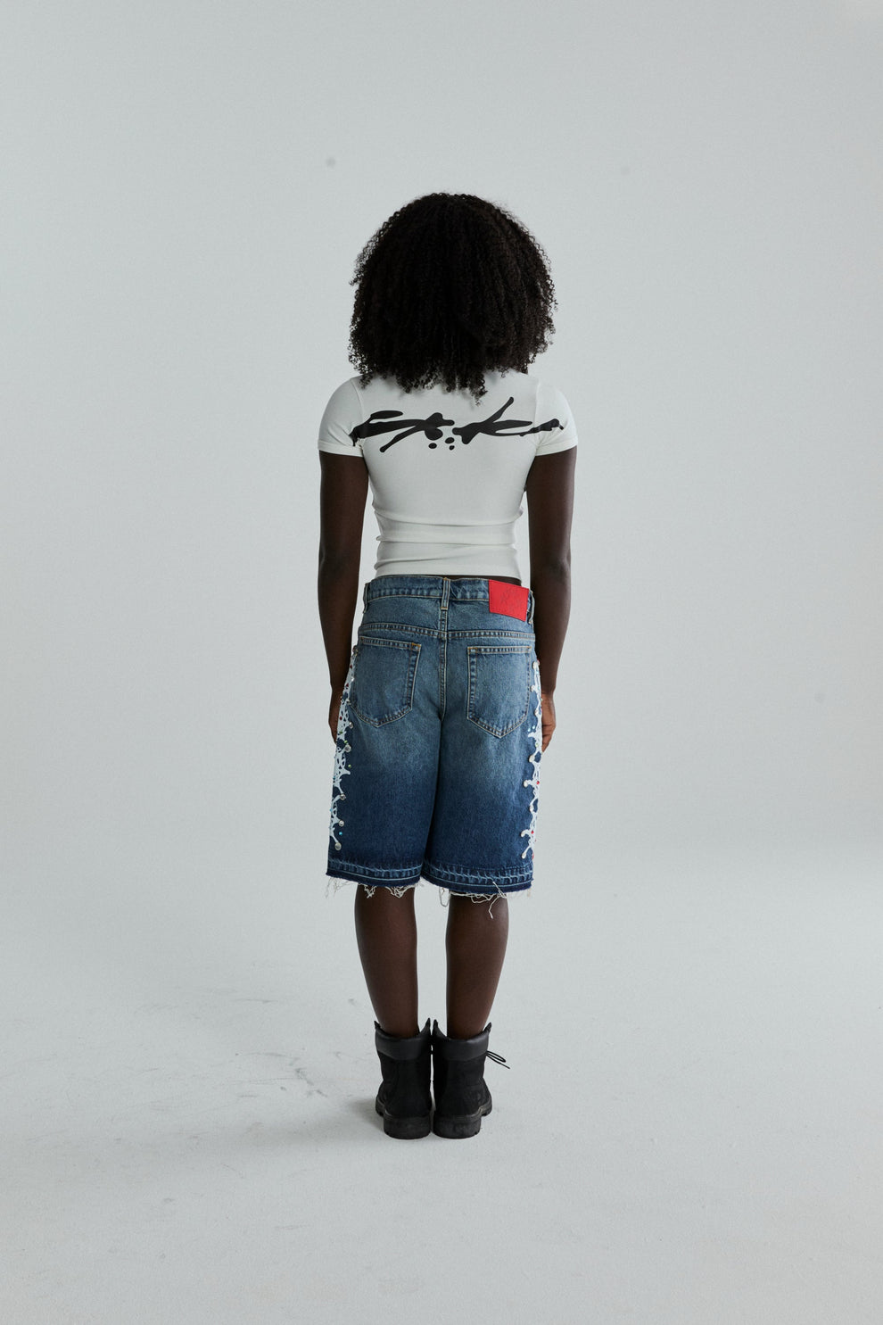 WHITE TM BABY TEE ON MODEL