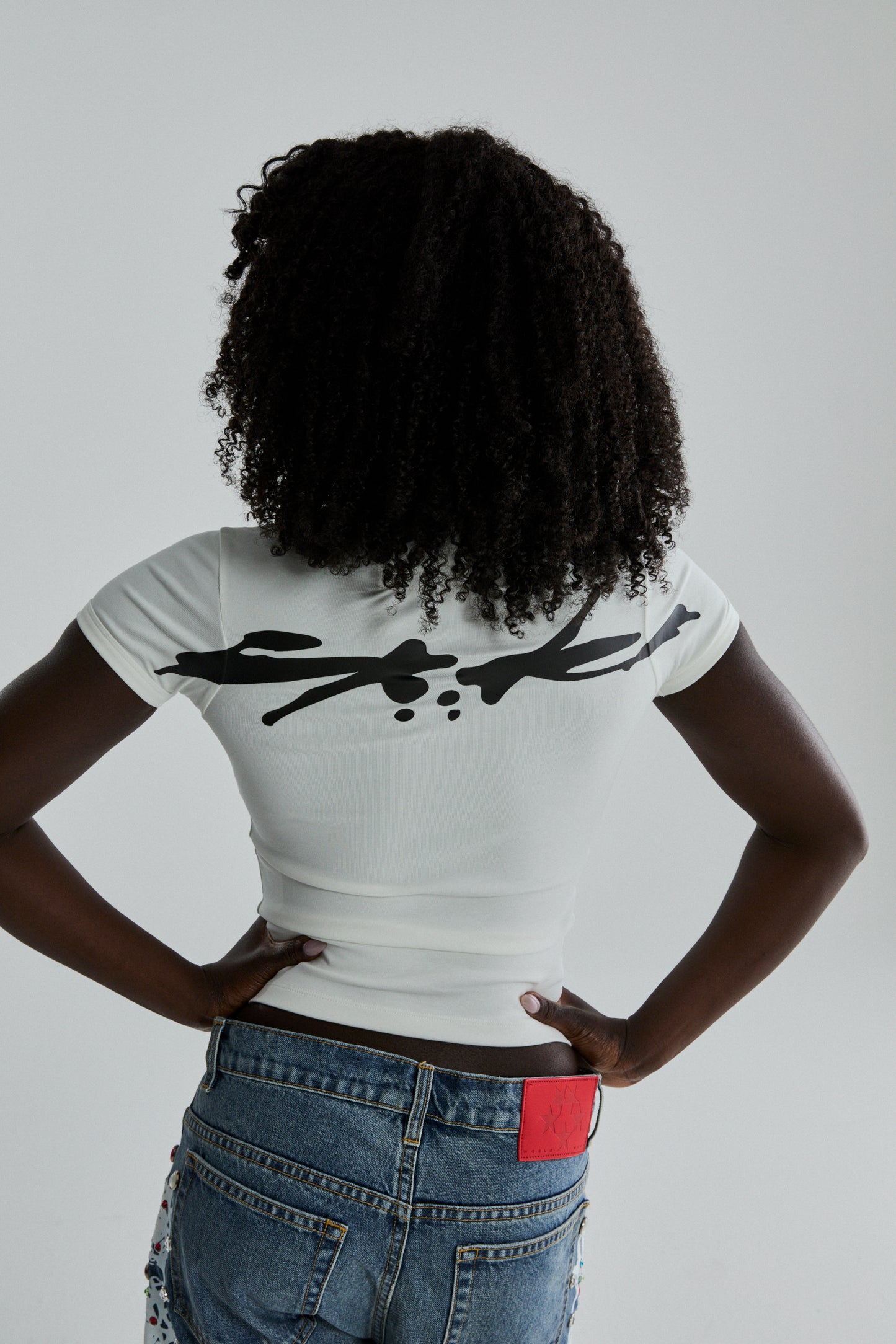 WHITE TM BABY TEE ON MODEL