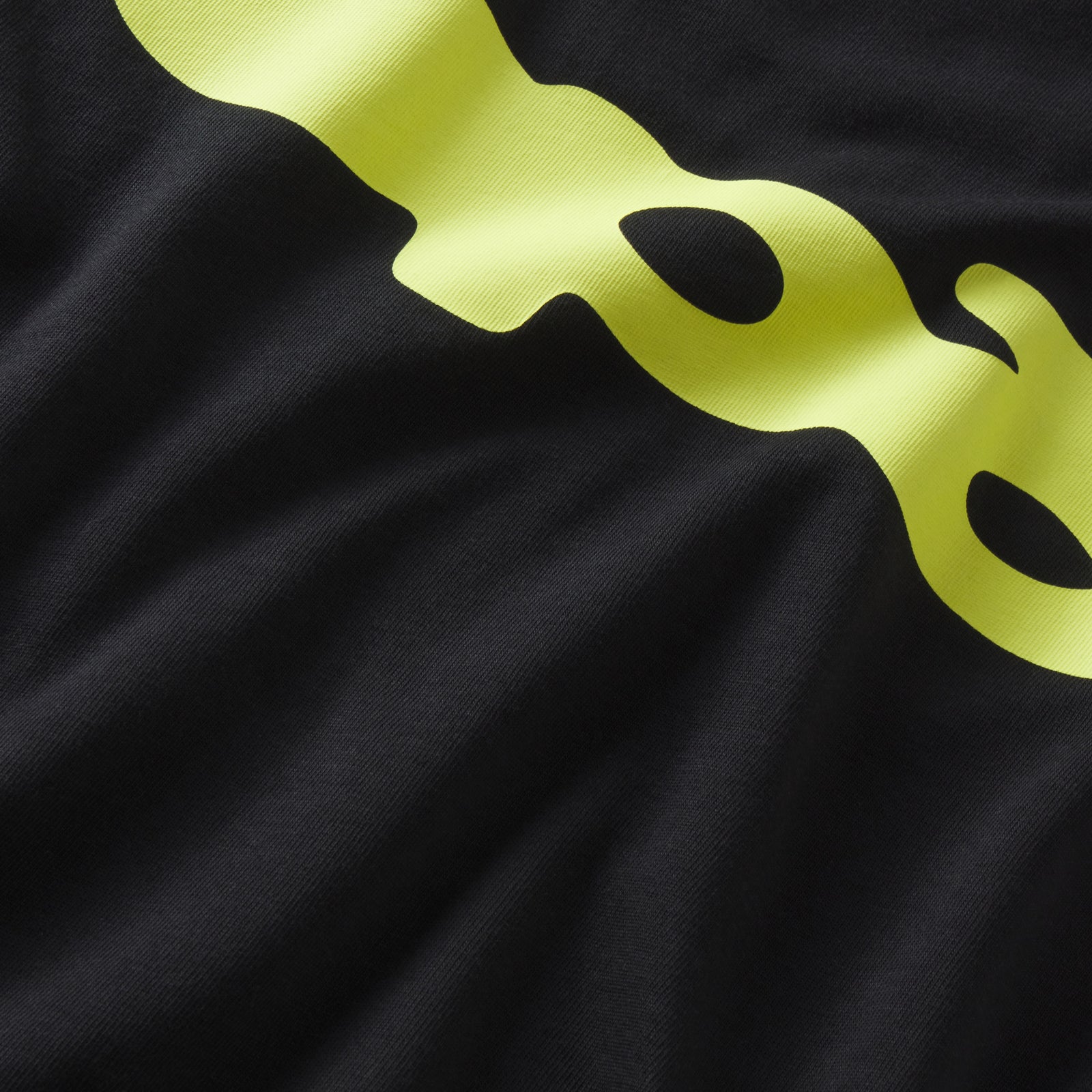 Black 100% cotton SP5 Bubble tee featuring a bold, bright yellow graphic print design on the front.