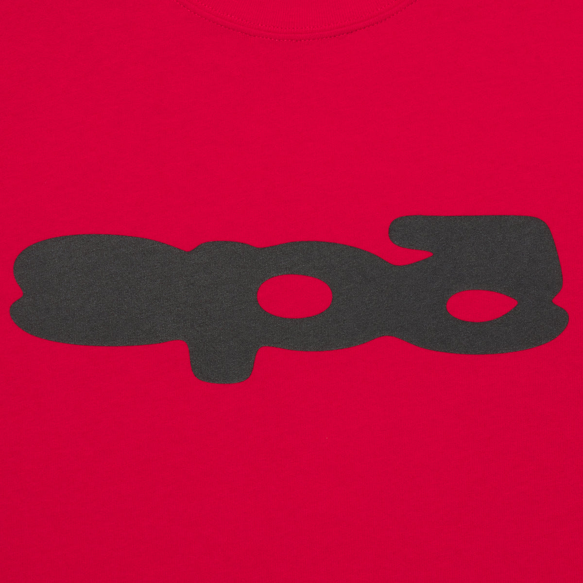 Bright red 100% cotton tee featuring a black bubble-style graphic print on the front in a standard fit.