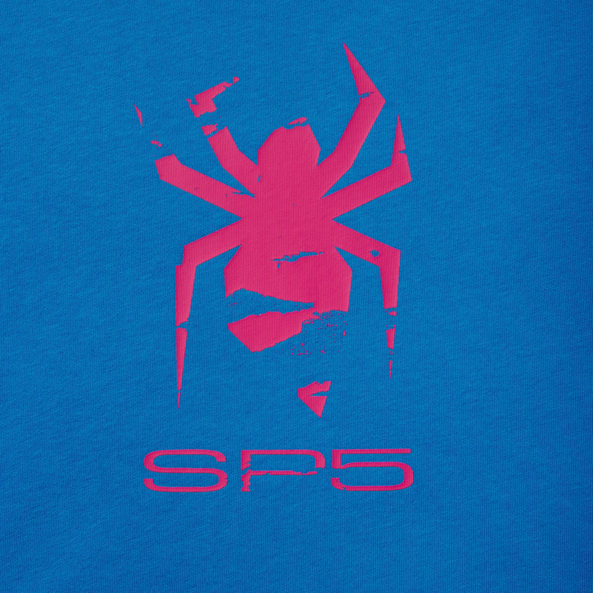 Bright blue 100% cotton tee featuring a distressed pink spider graphic print and SP5 lettering on the front.