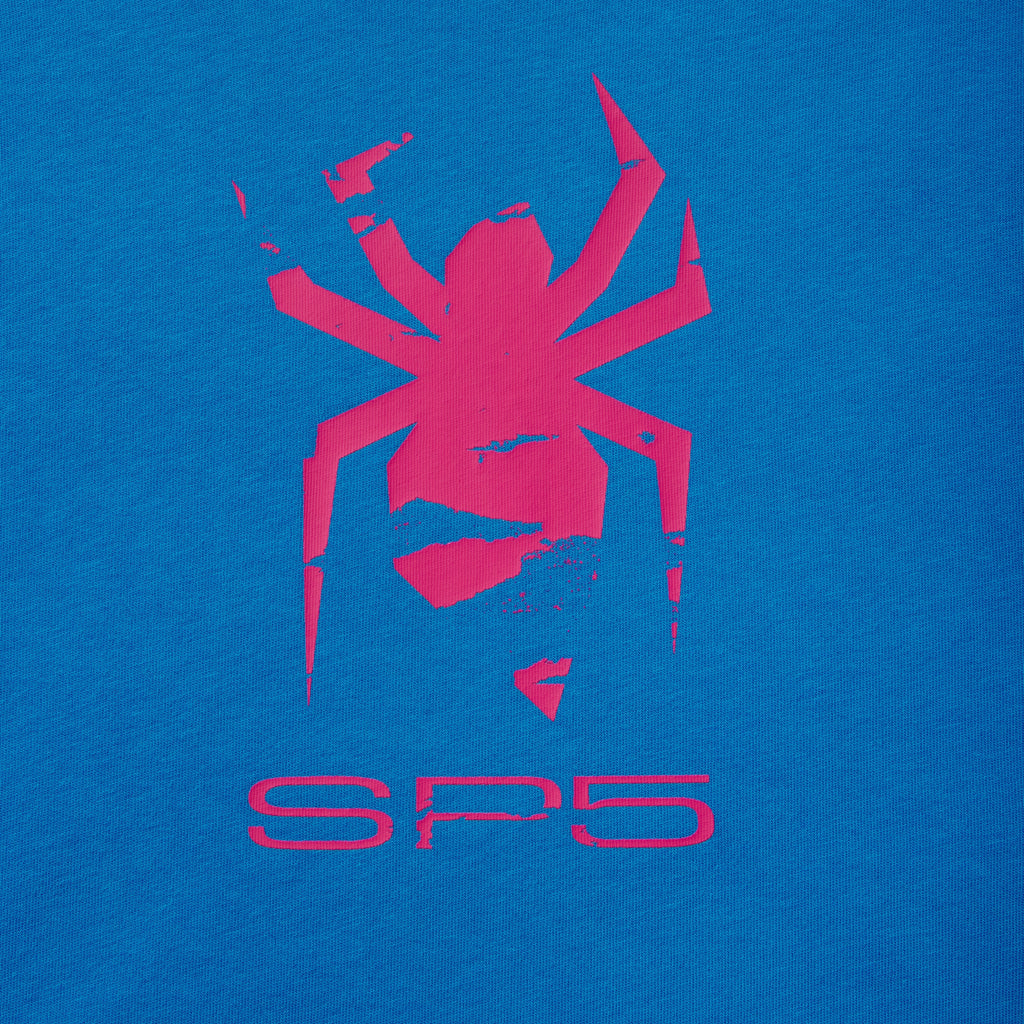 Bright blue 100% cotton tee featuring a distressed pink spider graphic print and SP5 lettering on the front.