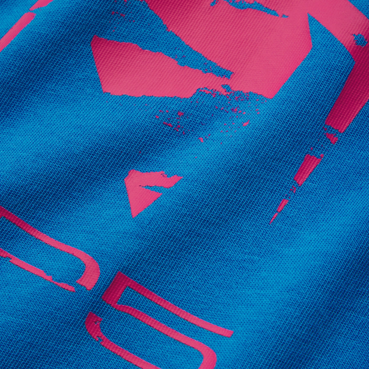 Bright blue 100% cotton tee featuring a distressed pink graphic print design.