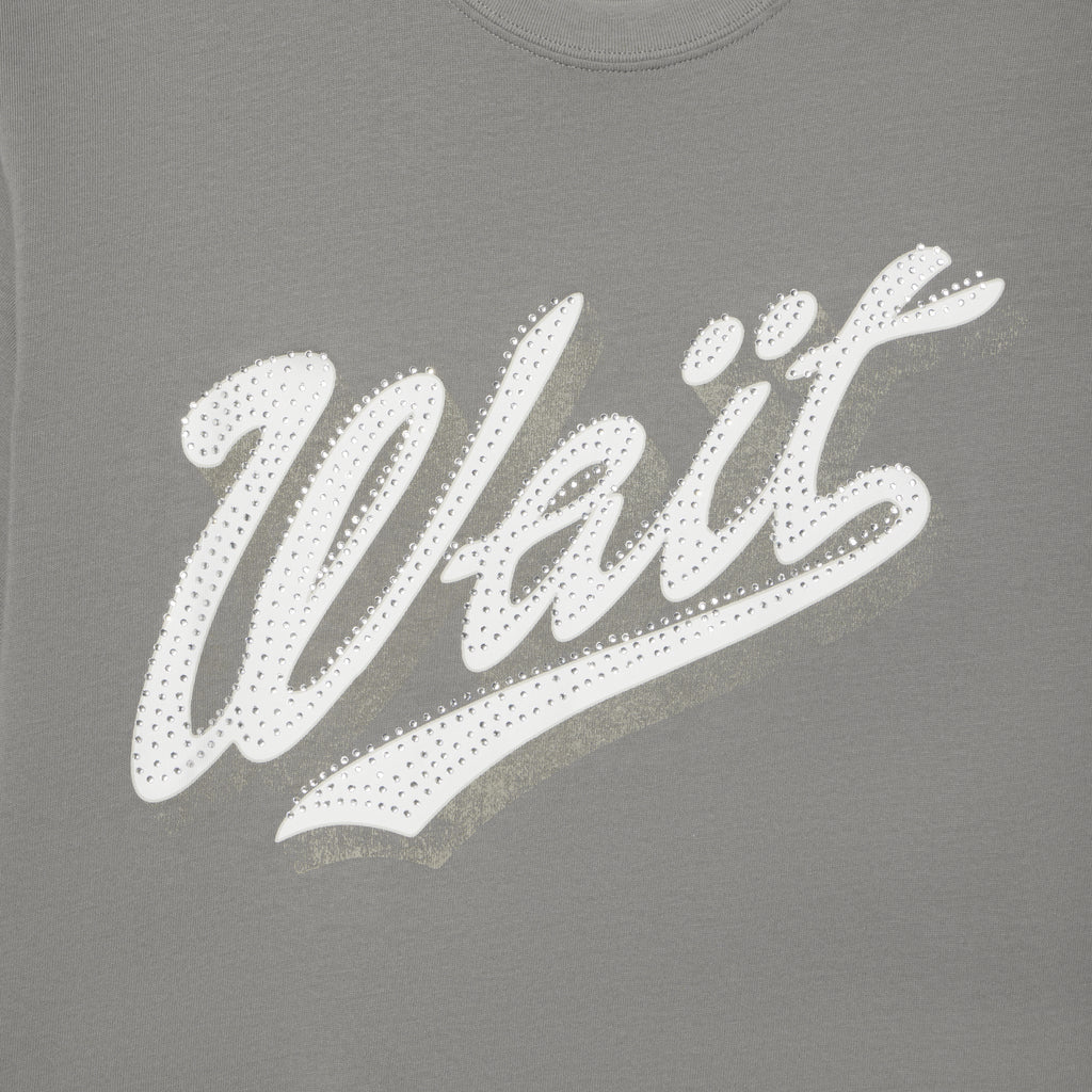 Grey 100% cotton t-shirt featuring a white graphic print of the word Wait embellished with sparkling rhinestone details.