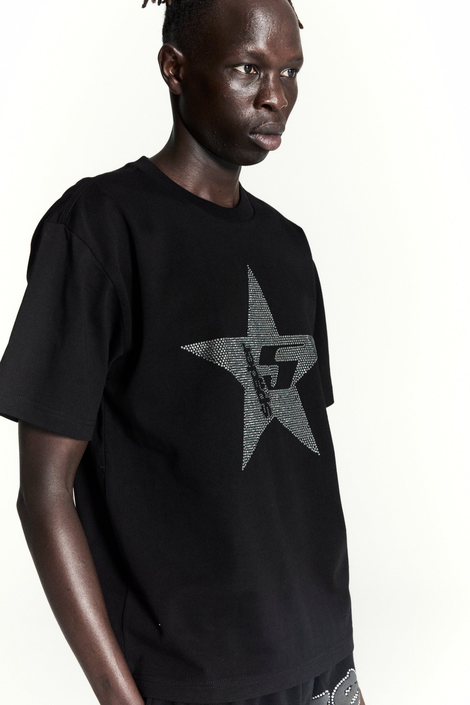 Black 100% cotton tee with a rhinestone-embellished 5-star design, worn by a model.