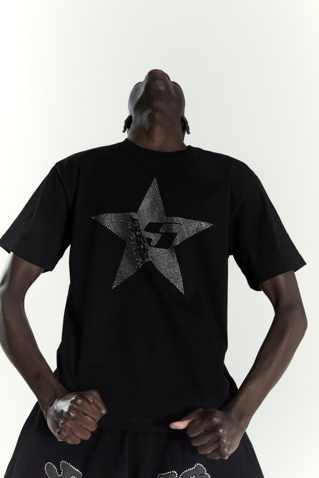 Black 100% cotton tee with a large rhinestone-embellished 5-star design on the back.